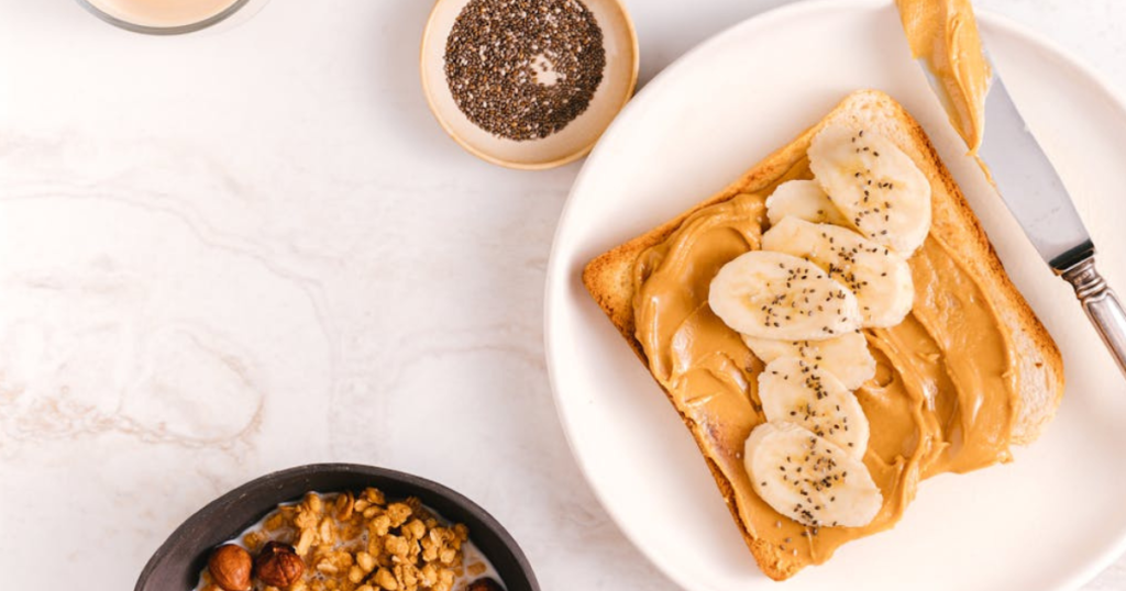 Close-up of a grilled peanut butter and banana sandwich with golden, crispy bread and creamy, melted peanut butter and banana slices inside. Served on a rustic plate, perfect for a comforting snack or quick meal