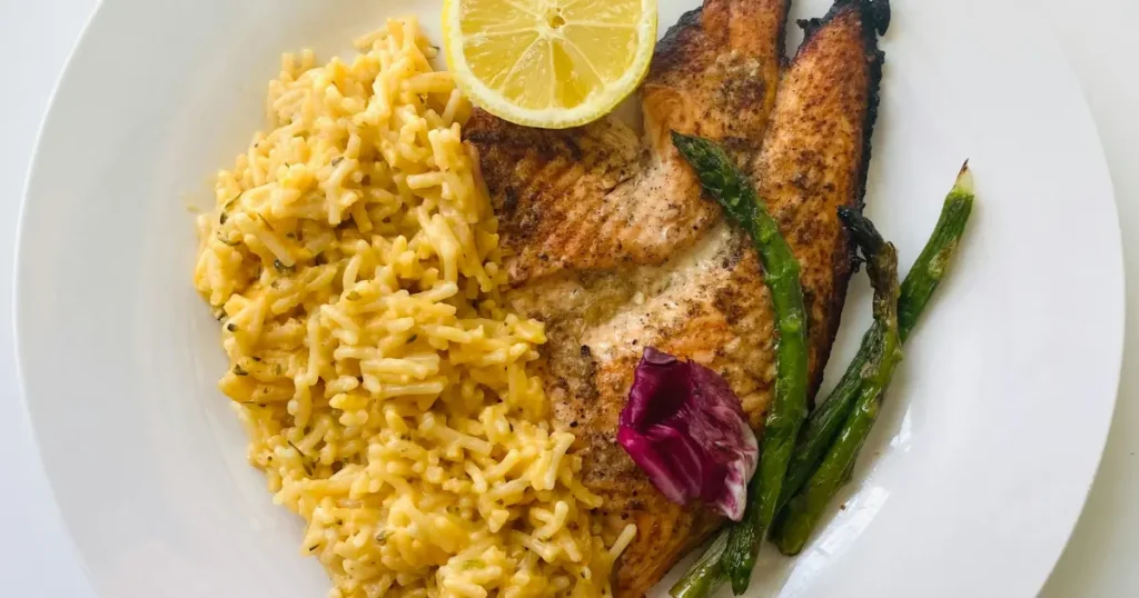 Grilled Salmon with Rice and Asparagus served fresh on a white plate