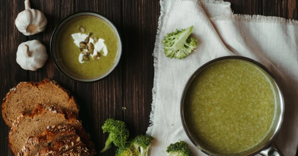 A comforting bowl of Easy Healthy Chicken Broccoli Soup with tender chicken, vibrant green broccoli florets, and a creamy light broth, garnished with fresh parsley and served on a rustic wooden table.