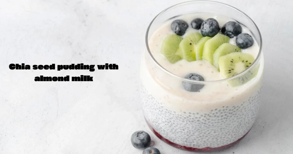 A bowl of creamy chia seed pudding topped with fresh berries and a sprinkle of granola, served on a wooden table.